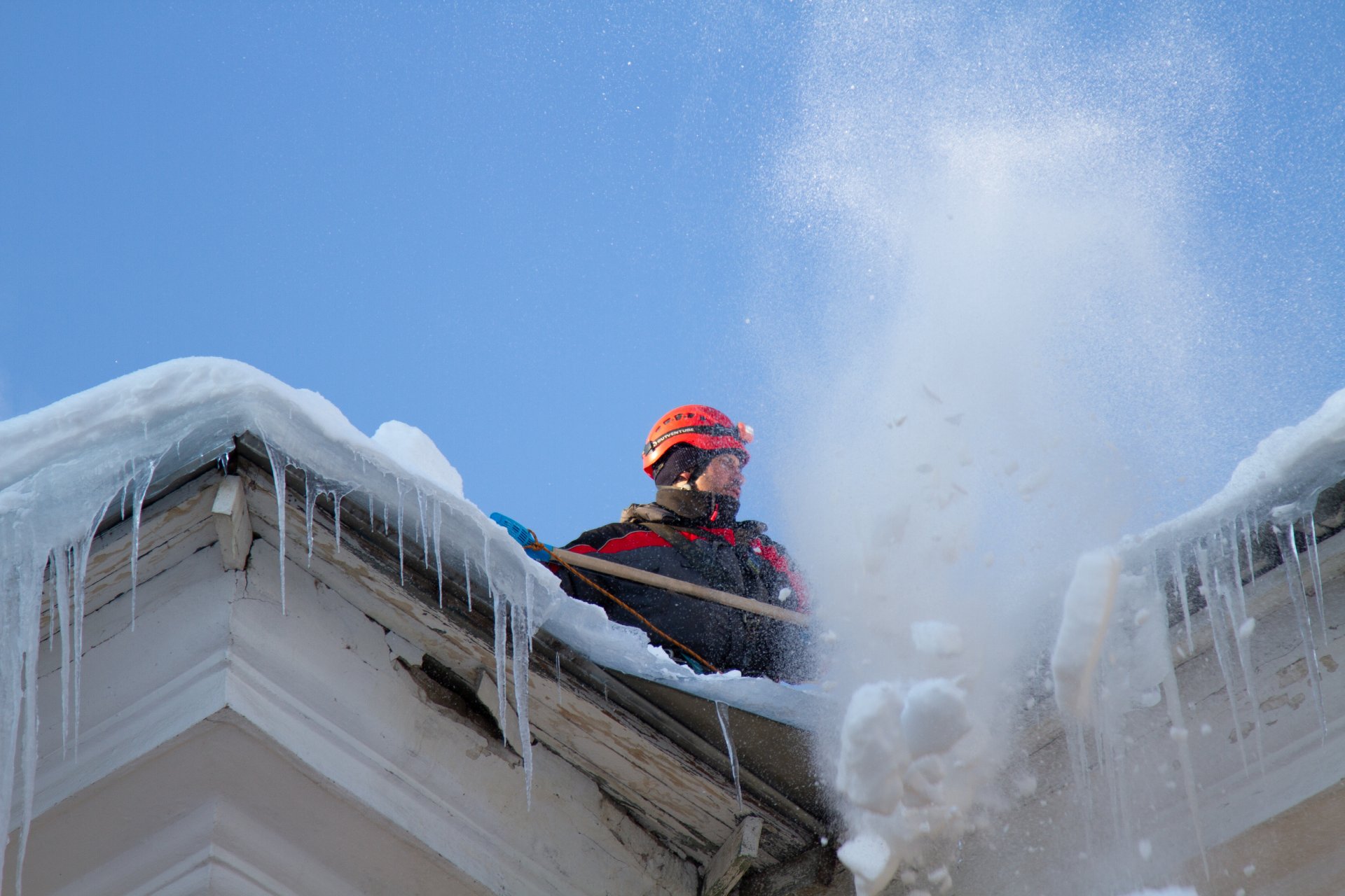 A-man-removing-snow-from-the-roof